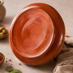 Terracotta base of handmade Moroccan cooking tagine showing glazed ceramic finish